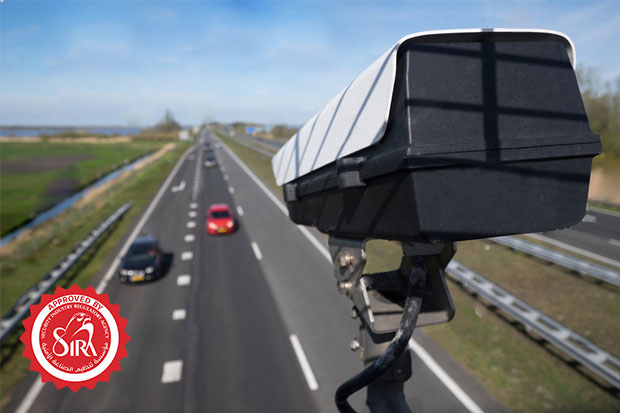 image of a titanhz anpr camera mounted on a horizontal pole, capturing vehicle data on a highway for number plate recognition and traffic monitoring.