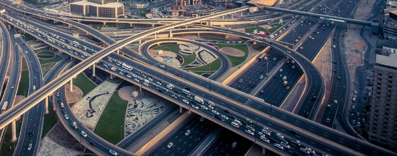 image of multiple cars passing over a flyover, showcasing highway access control with automated number plate recognition for traffic management.