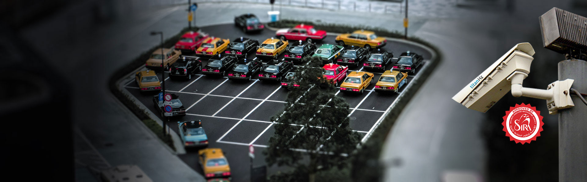 banner image of an outdoor parking area with multiple cars parked, monitored by titanhz anpr parking cameras mounted on a pole for security and access control.