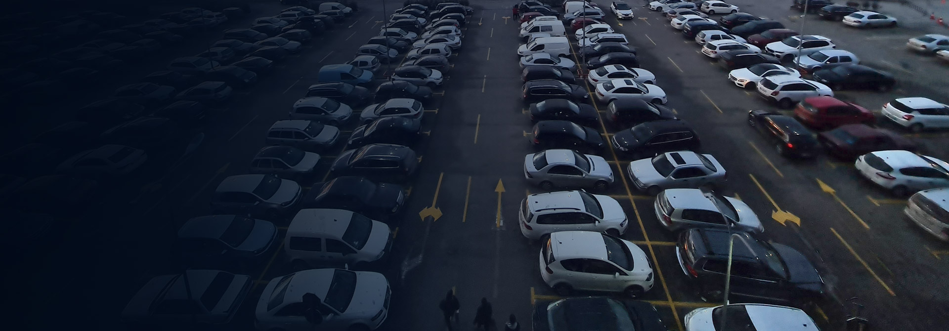 Banner image showing multiple cars parked in an ANPR parking system, showcasing automated number plate recognition technology.