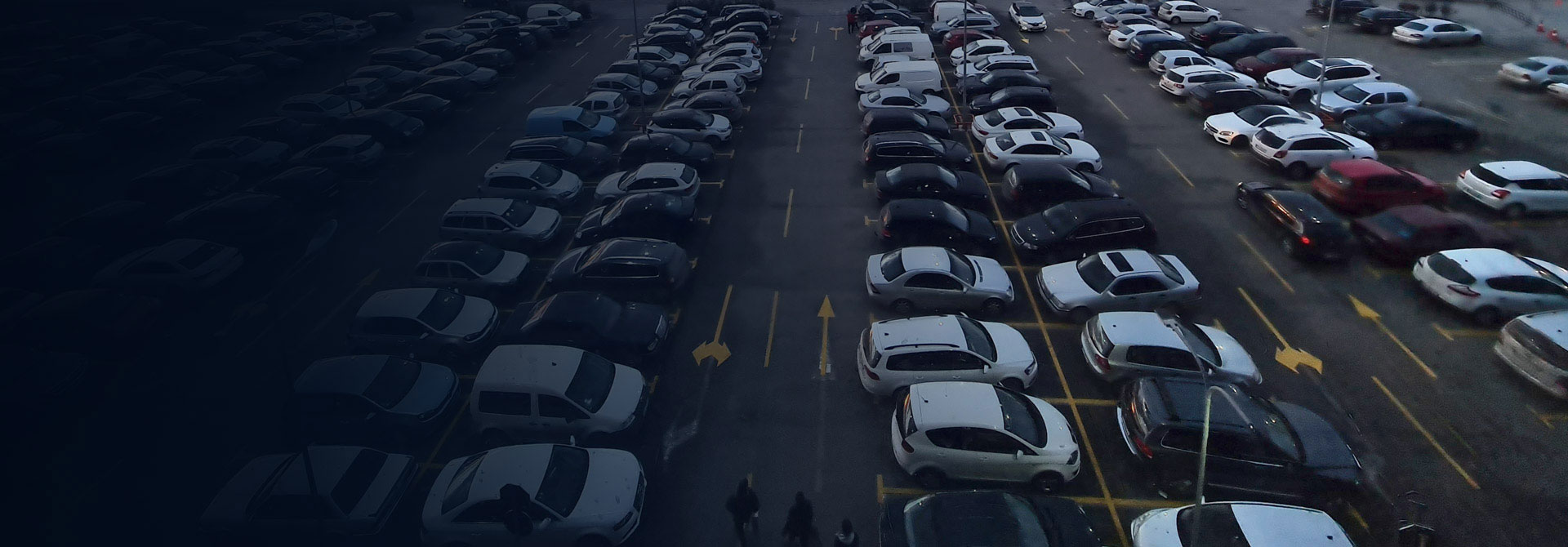 Banner image showing multiple cars parked in an ANPR parking system, showcasing automated number plate recognition technology.