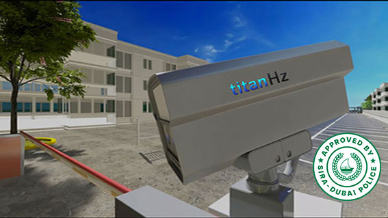 a parking area with buildings in the background, a titanhz anpr camera mounted at the entrance, and a boom barrier for access control.