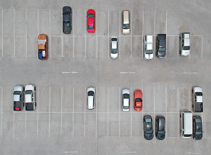 a top view of a parking zone with multiple cars parked, showcasing organized parking and vehicle management solutions.