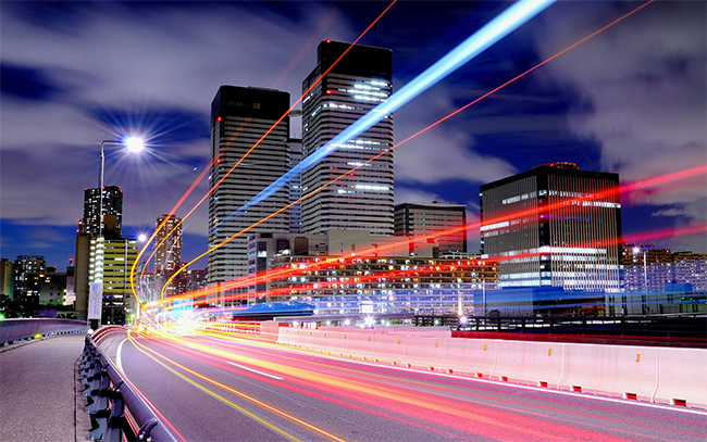 a city scene with multiple light streaks, representing the advanced technology of anpr security system engines for monitoring.