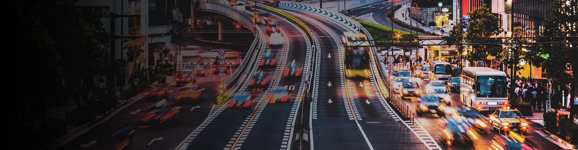 a motion-blurred banner image of a city flyover with multiple cars driving, showcasing anpr security systems for traffic monitoring.