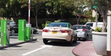 multiple cars entering parking zone, with boom barriers opening for each car, monitored by ANPR parking system