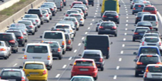 multiple cars passing in a line on the highway, monitored by ANPR system for security and vehicle tracking