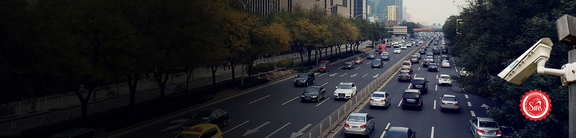 a banner image of a highway with two lanes, multiple cars passing, and an anpr camera mounted for congestion charging solutions.