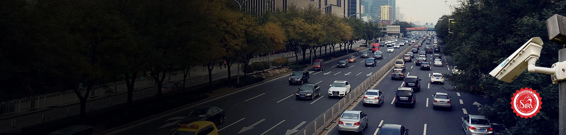 a banner image of a highway with two lanes, multiple cars passing, and an anpr camera mounted for congestion charging solutions.