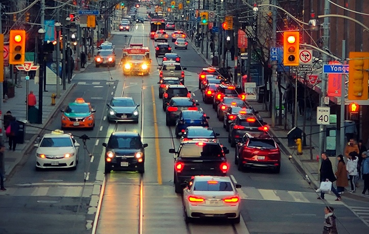 an urban city scene with multiple cars passing and traffic lights, showcasing traffic monitoring and management solutions.